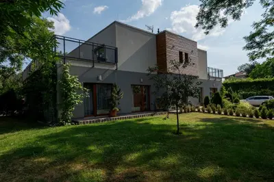 a house with a green lawn in front of it at Rezidence & Wellness Blatov in Prague