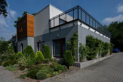 a house with a balcony on top of it at Rezidence & Wellness Blatov in Prague