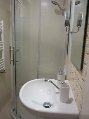 a bathroom with a sink and a glass shower at Museum Inn in Prague