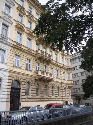 a large building with cars parked in front of it at Museum Inn in Prague