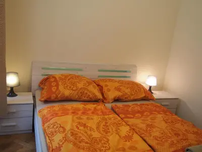 a bedroom with a bed with two lamps on both sides at Museum Inn in Prague