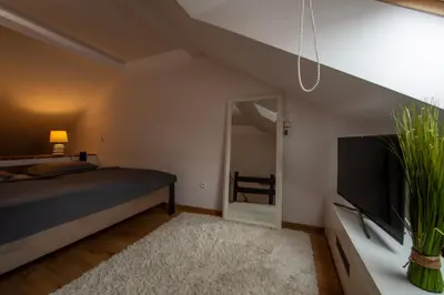 a bedroom with a bed and a flat screen tv at Apartmány Ztracená in Roudnice nad Labem
