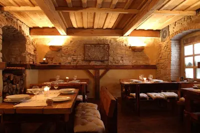 a restaurant with wooden tables and chairs in a room at Apartmány Ztracená in Roudnice nad Labem