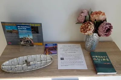 a wooden table with a vase of flowers and a book at ONSITE Free Garage Parking, 10min Centre by Bus in Prague