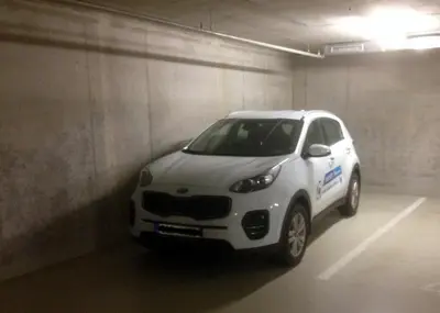 a white car parked in a parking garage at ONSITE Free Garage Parking, 10min Centre by Bus in Prague