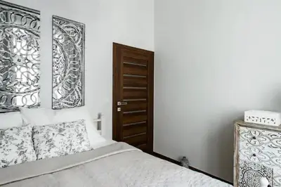 a bedroom with a bed and a wooden door at Luxury apartment at Prague city centre Anděl! in Prague