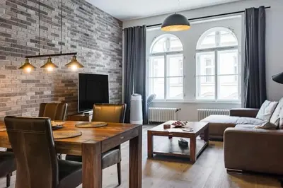 a living room with a table and a living room with a couch at Luxury apartment at Prague city centre Anděl! in Prague