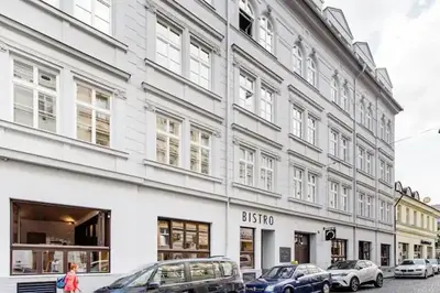 a large white building with cars parked in front of it at Luxury apartment at Prague city centre Anděl! in Prague