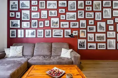 a living room with a couch and a wall of pictures at Luxury apartment at Prague city centre Anděl! in Prague