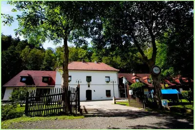a white house with a fence in front of it at Motel Svatý Kryštof in Liběchov