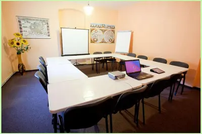 a conference room with a table and chairs and a laptop at Motel Svatý Kryštof in Liběchov