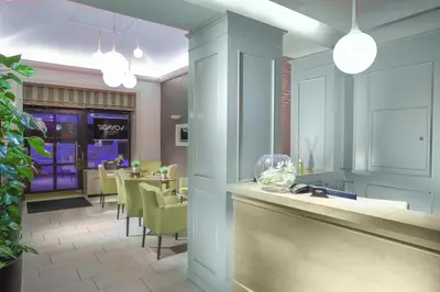 a restaurant with a bar and a dining room at Hotel Hartig in Prague