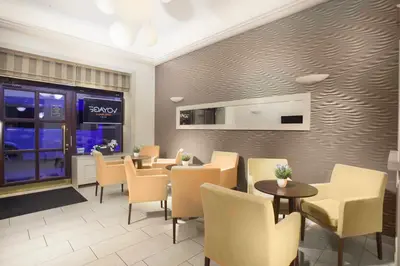 a restaurant with tables and chairs in a room at Hotel Hartig in Prague