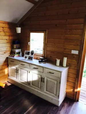 a kitchen with a counter in a wooden room at Summer lake in Chotilsko