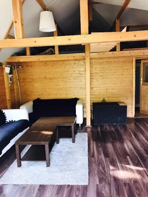 a living room with a table and a couch at Summer lake in Chotilsko