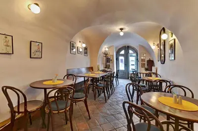 a restaurant with tables and chairs in a room at Penzion Na Letním bytě in Kouřim