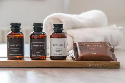 three bottles of honey and a bag on a wooden tray at Exclusive Old Town residence near Charles Bridge in Prague