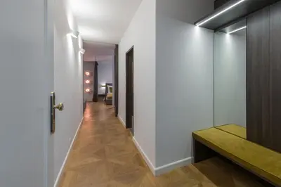 a hallway with a white door and a wooden floor at Exclusive Old Town residence near Charles Bridge in Prague