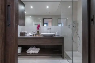 a bathroom with a sink and a glass shower at Exclusive Old Town residence near Charles Bridge in Prague