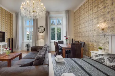a living room with a couch and a table at Mikulášská - Old Town Square View Residence in Prague