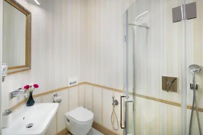 a bathroom with a toilet and a sink and a shower at Mikulášská - Old Town Square View Residence in Prague