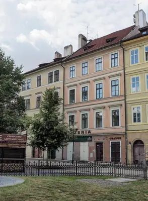 a large building with a fence in front of it at Mikulášská - Old Town Square View Residence in Prague