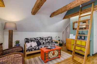 a living room with a couch and a bunk bed at Old Town Square Apartments by Michal&Friends in Prague