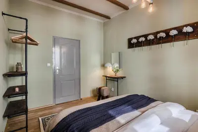 a bedroom with a bed with a blue blanket at Old Town Square Apartments by Michal&Friends in Prague