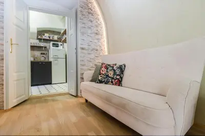 a living room with a white couch and a kitchen at Old Town Square Apartments by Michal&Friends in Prague