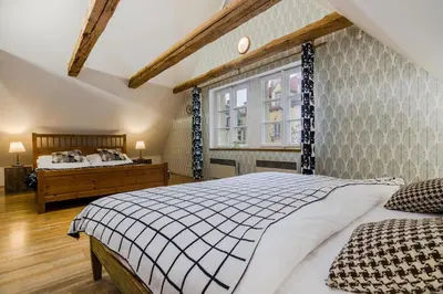 a bedroom with a bed and a window at Old Town Square Apartments by Michal&Friends in Prague