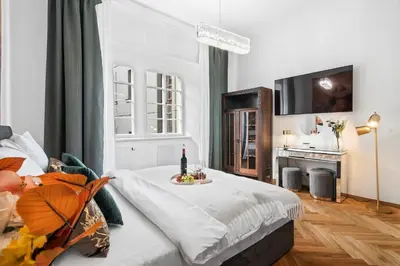 a bedroom with a bed with a tray of food on it at Old Town Square Apartments by Michal&Friends in Prague