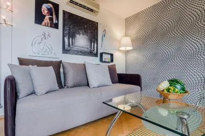 a living room with a couch and a glass table at Prague 1 SUNNY APT with terrace by Michal&Friends in Prague