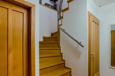 a stairwell with a wooden door and a stair railing at Prague 1 SUNNY APT with terrace by Michal&Friends in Prague