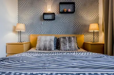a bedroom with a bed with two pillows and two lamps at Prague 1 SUNNY APT with terrace by Michal&Friends in Prague