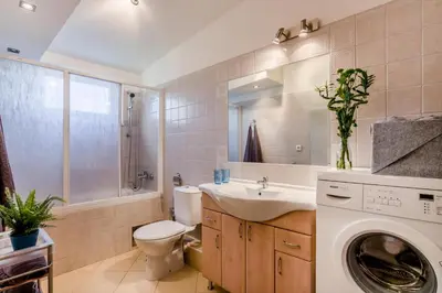 a bathroom with a washing machine and a sink at Prague 1 SUNNY APT with terrace by Michal&Friends in Prague