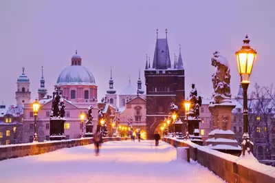 a view of a city in the snow at night at Prague 1 SUNNY APT with terrace by Michal&Friends in Prague