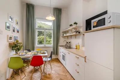 a kitchen with a table and chairs and a dining room at Historic Centre Prague Apartments by Michal&Friends in Prague