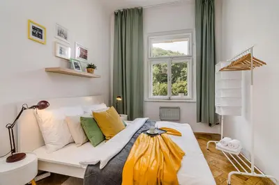 a living room with a white couch and a window at Historic Centre Prague Apartments by Michal&Friends in Prague