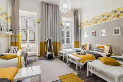 a room with two beds and a living room with yellow at Historic Centre Prague Apartments by Michal&Friends in Prague