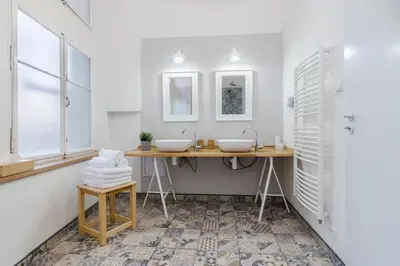 a bathroom with two sinks and two mirrors at Historic Centre Prague Apartments by Michal&Friends in Prague