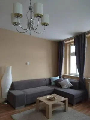 a living room with a couch and a table at NOT POSSIBLE TO BOOK Apartment Vltavska F in Prague