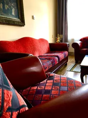 a living room with two couches and a red couch at NOT POSSIBLE TO BOOK Apartment Vltavska F in Prague