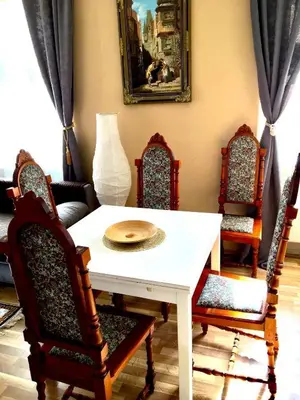 a dining room with a white table and chairs at NOT POSSIBLE TO BOOK Apartment Vltavska F in Prague