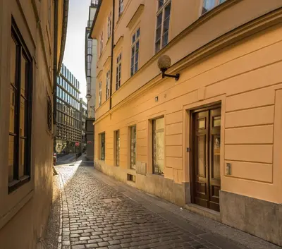 an empty street in an alley between two buildings at The MadHouse Prague in Prague