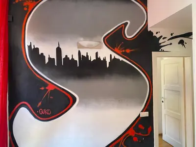 a mural of a city on a wall at The MadHouse Prague in Prague