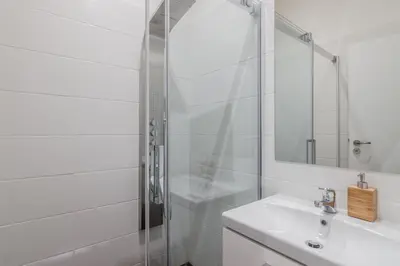 a white bathroom with a shower and a sink at Prague APT near Charles Bridge by Michal&Friends in Prague