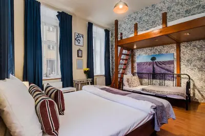 a bedroom with two beds and a canopy bed at Prague APT near Charles Bridge by Michal&Friends in Prague