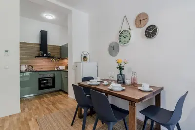 a kitchen and dining room with a wooden table and chairs at Zizkov APT Prague by Michal&Friends in Prague
