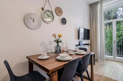 a dining room with a wooden table and chairs at Zizkov APT Prague by Michal&Friends in Prague