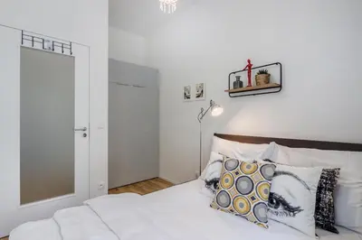 a bedroom with a bed with white sheets and pillows at Zizkov APT Prague by Michal&Friends in Prague